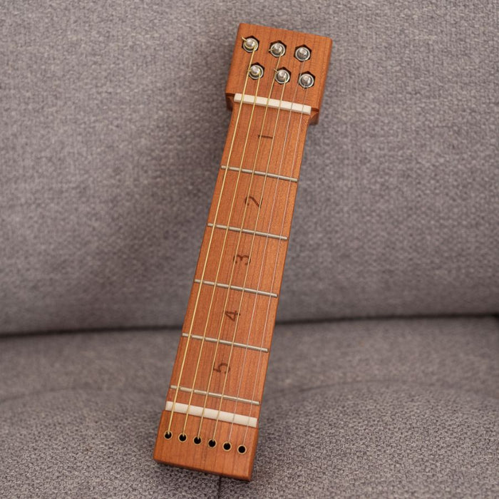 Chordly portable guitar trainer